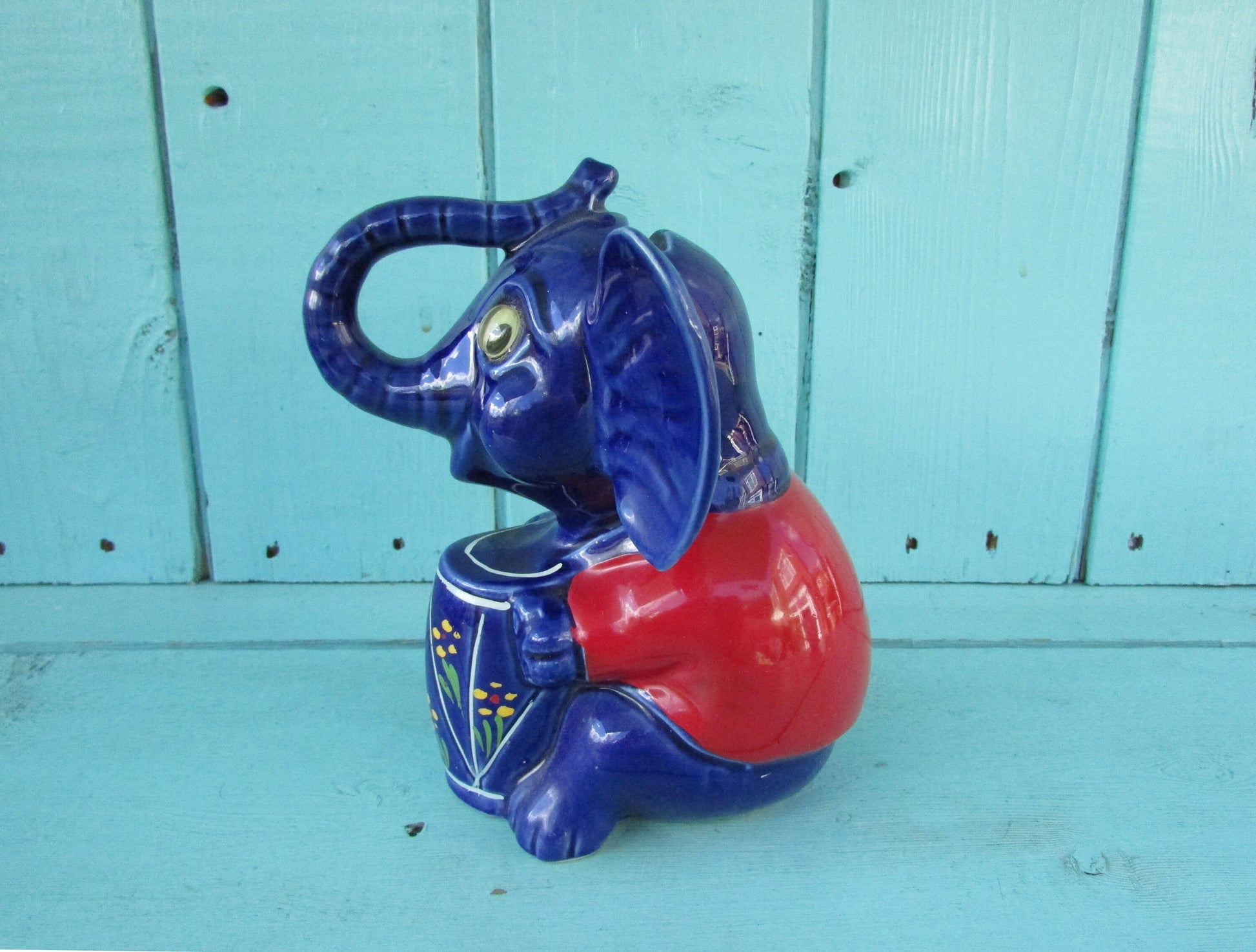 Vintage hand-painted blue ceramic elephant, with drum & googly eyes, money box