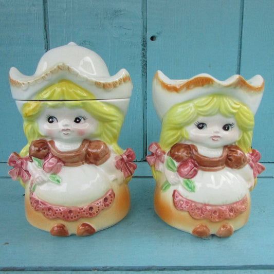 Pair of vintage ceramic Dutch girls in traditional costume lidded milk jug & sugar pot