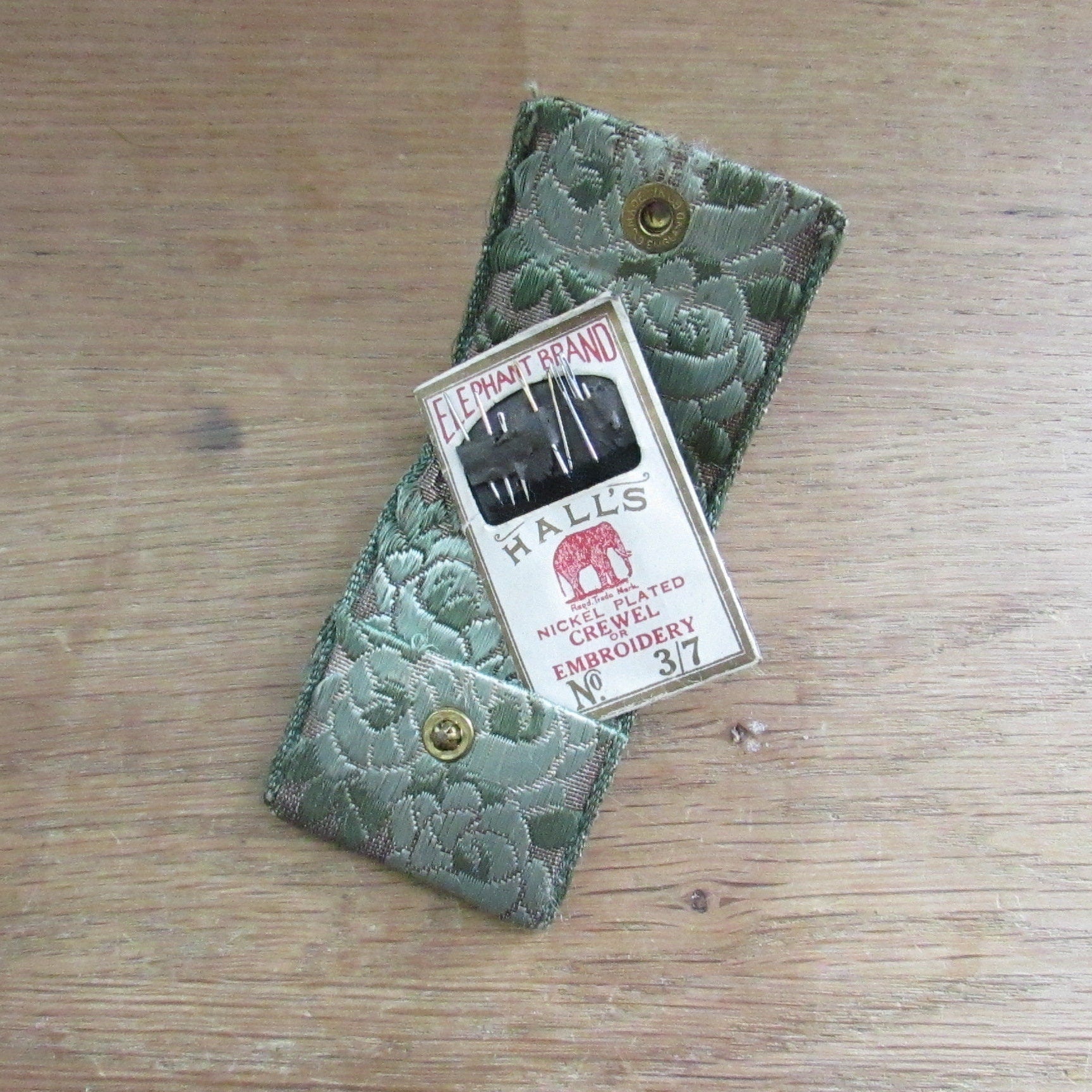 Vintage fabric needle case containing Elephant Brand Hall's nickel plated crewel or embroidery needles No.317