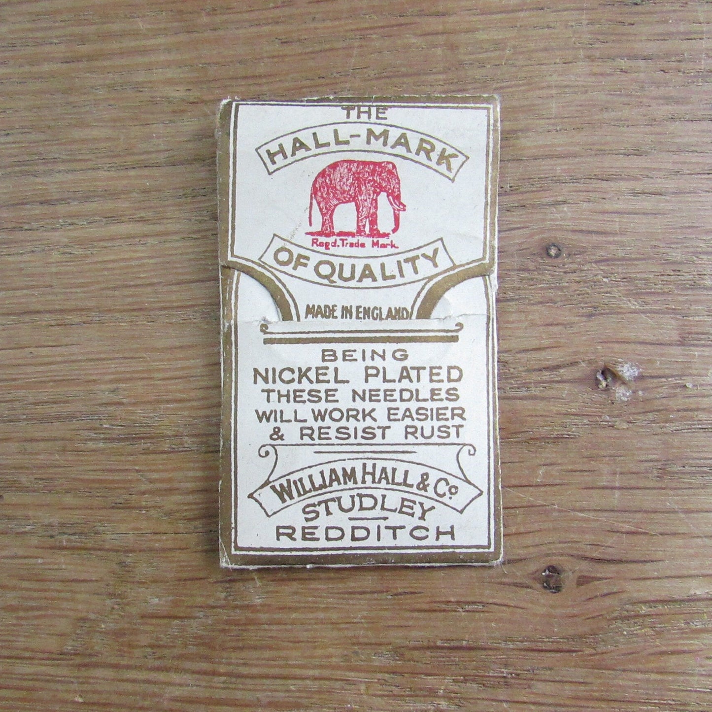 Vintage fabric needle case containing Elephant Brand Hall's nickel plated crewel or embroidery needles No.317