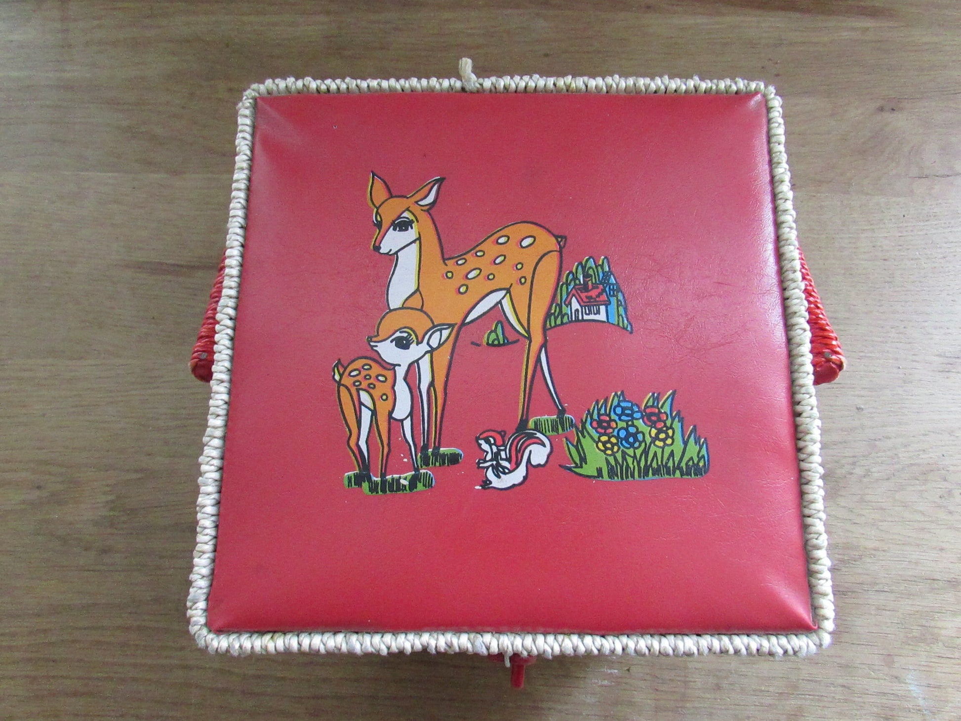 Mid-century red vinyl & wicker sewing box, depicting mother and baby deer