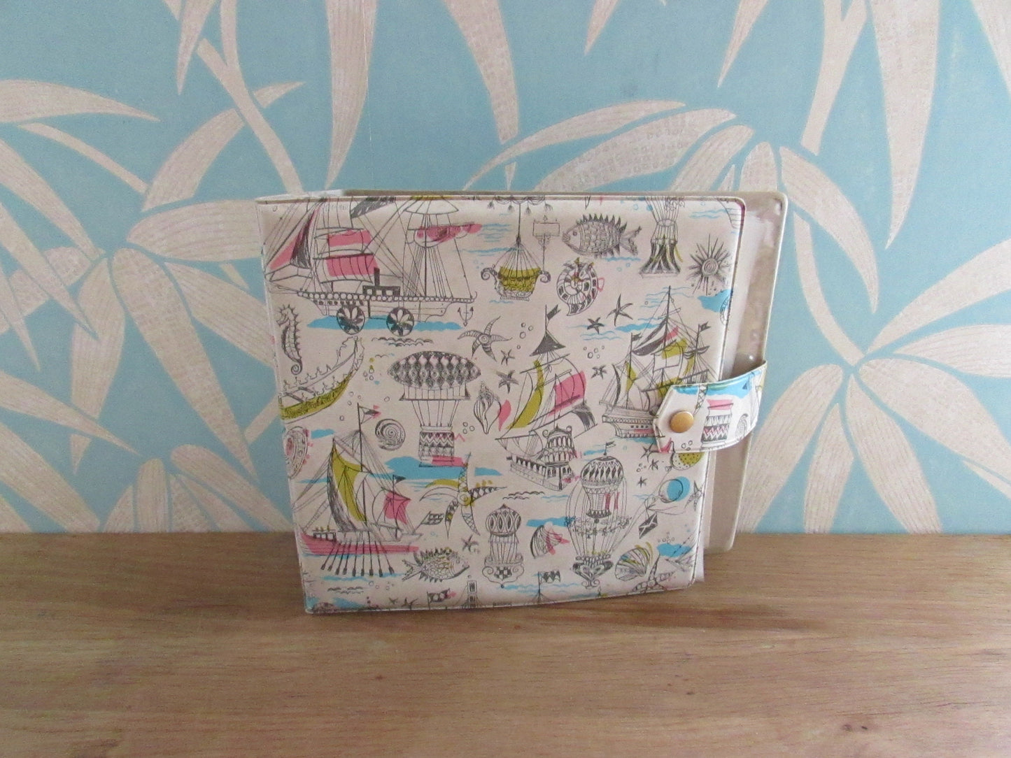 1960s hardcover vinyl record case for 7inch singles, illustrated with ships & hot air balloons