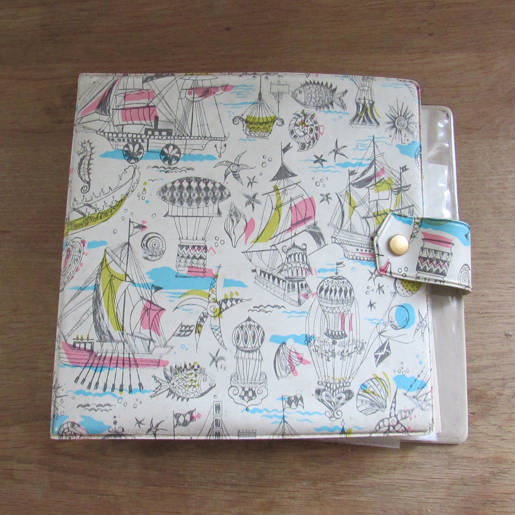 1960s hardcover vinyl record case for 7inch singles, illustrated with ships & hot air balloons