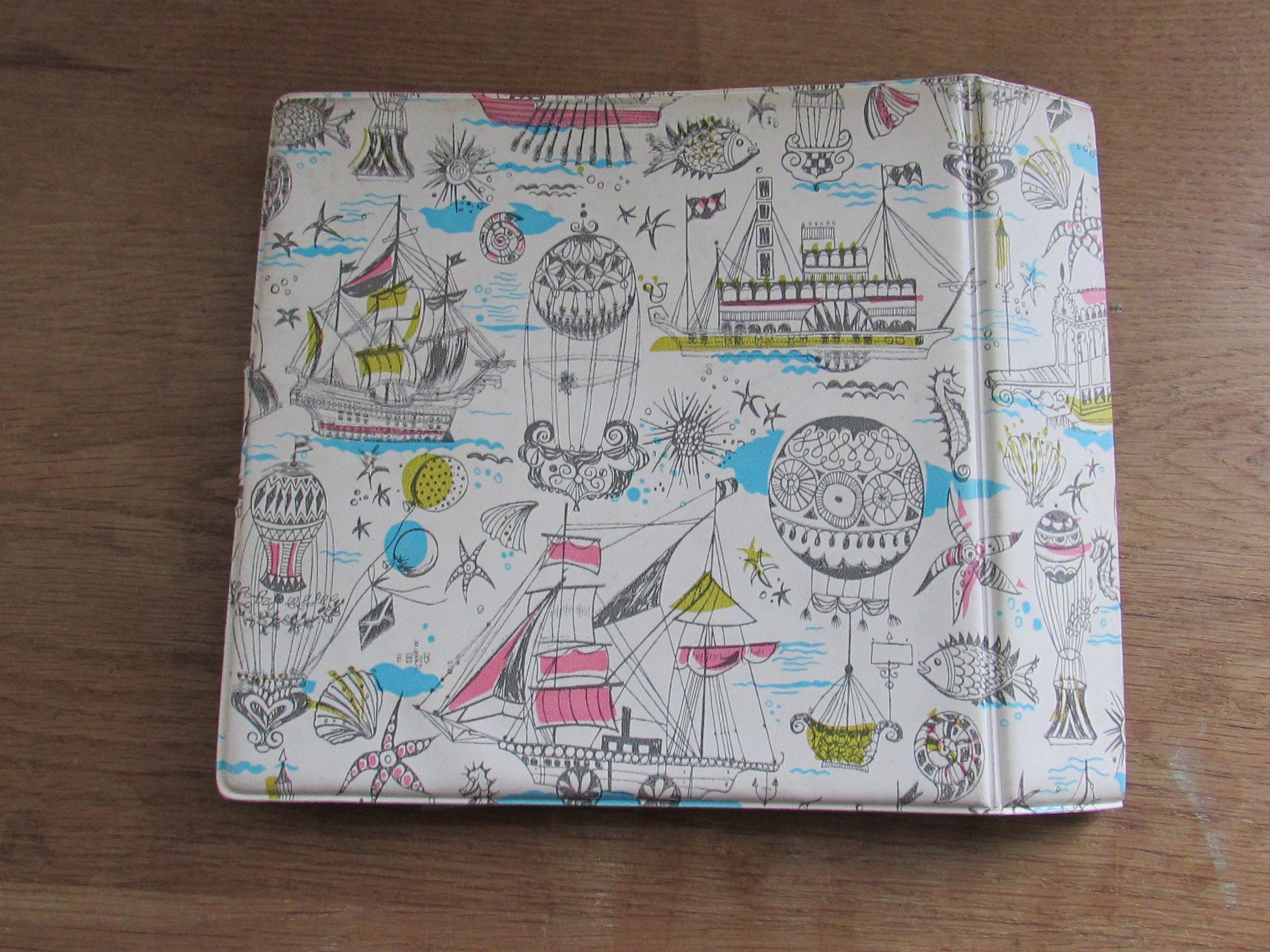 1960s hardcover vinyl record case for 7inch singles, illustrated with ships & hot air balloons