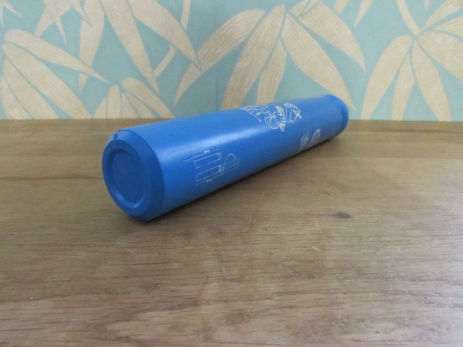 Vintage blue plastic certificate holder tube with cartoon motif