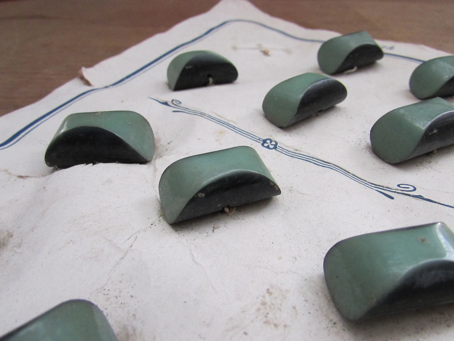 1930s Galalith carded two-tone green domed oblong buttons x11