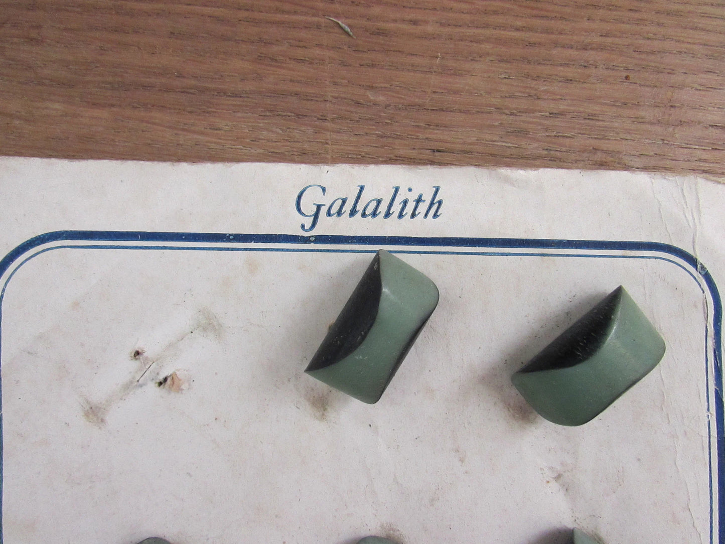 1930s Galalith carded two-tone green domed oblong buttons x11