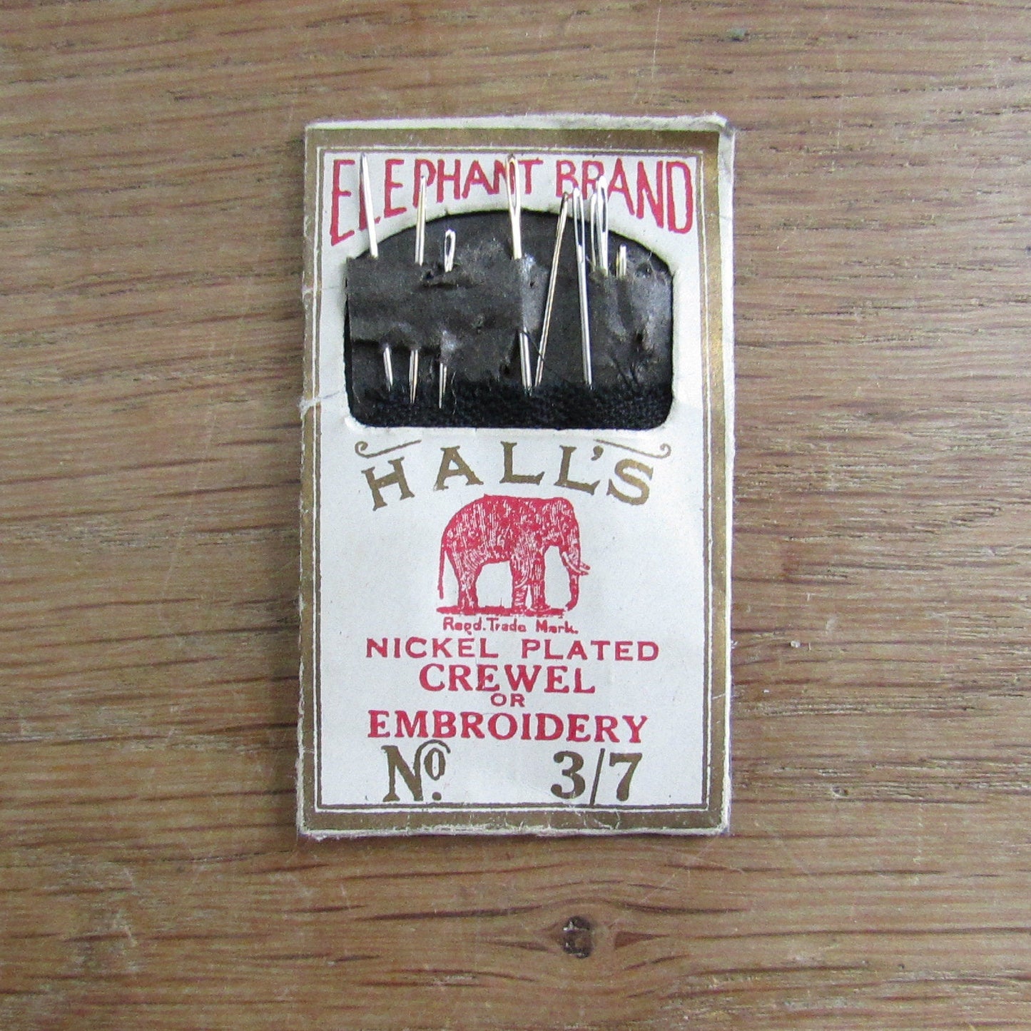 Vintage fabric needle case containing Elephant Brand Hall's nickel plated crewel or embroidery needles No.317