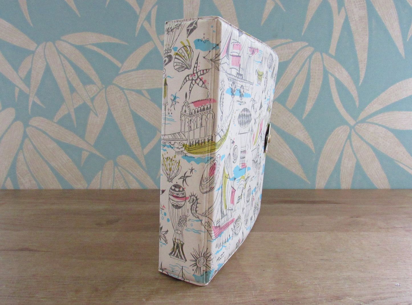 1960s hardcover vinyl record case for 7inch singles, illustrated with ships & hot air balloons