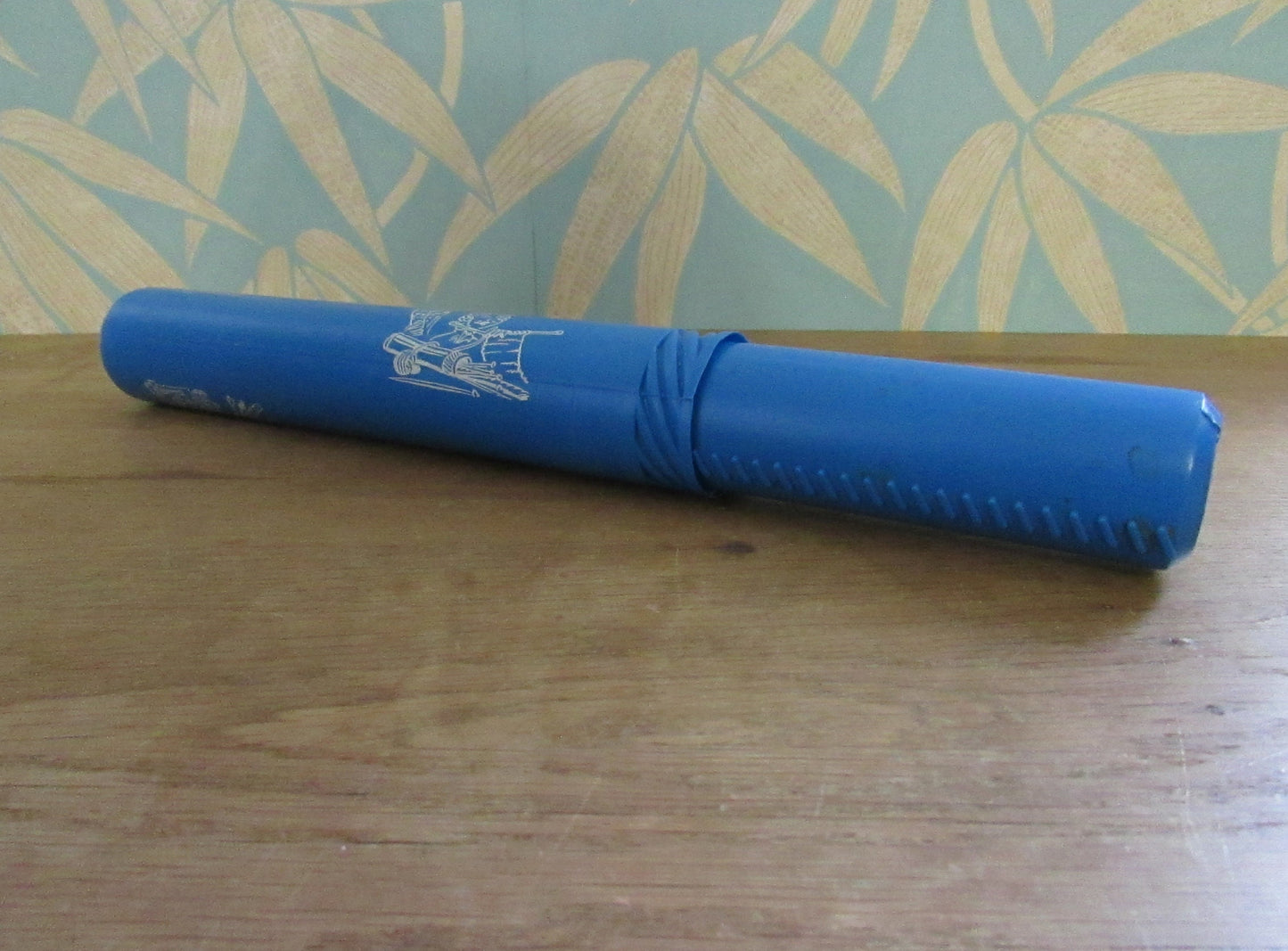 Vintage blue plastic certificate holder tube with cartoon motif