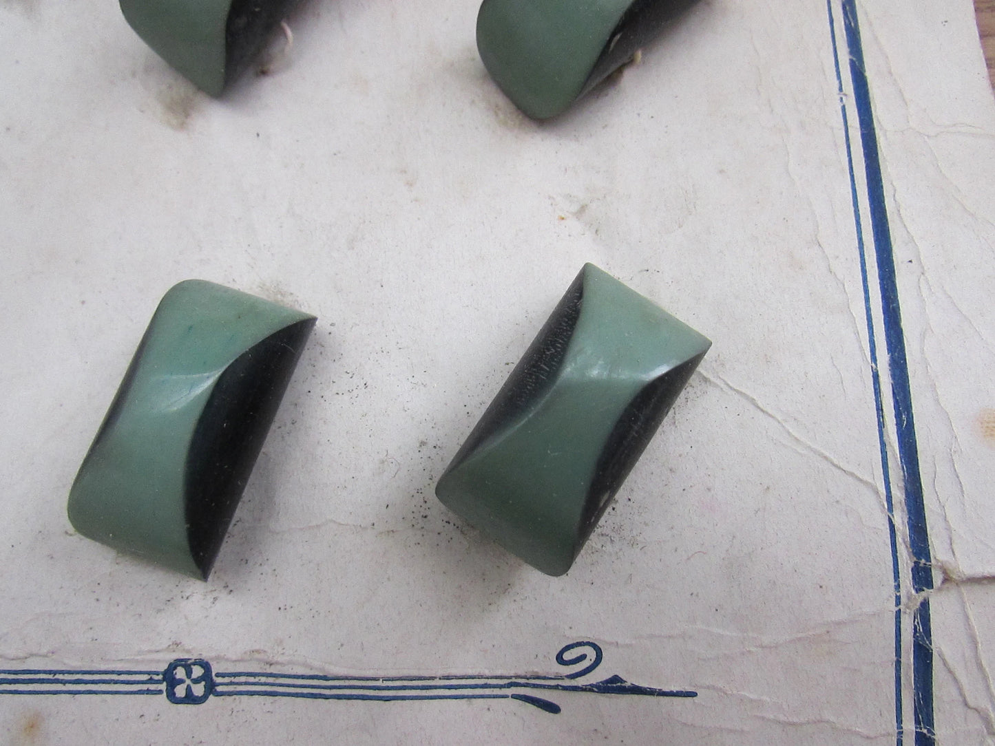 1930s Galalith carded two-tone green domed oblong buttons x11