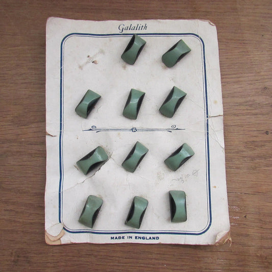 1930s Galalith carded two-tone green domed oblong buttons x11