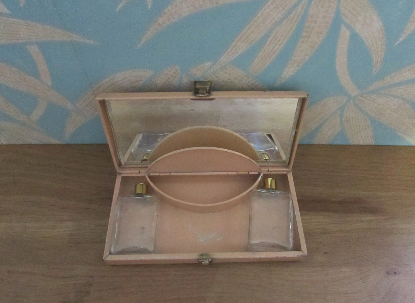 Mid-century travel vanity set in peach-coloured metal case