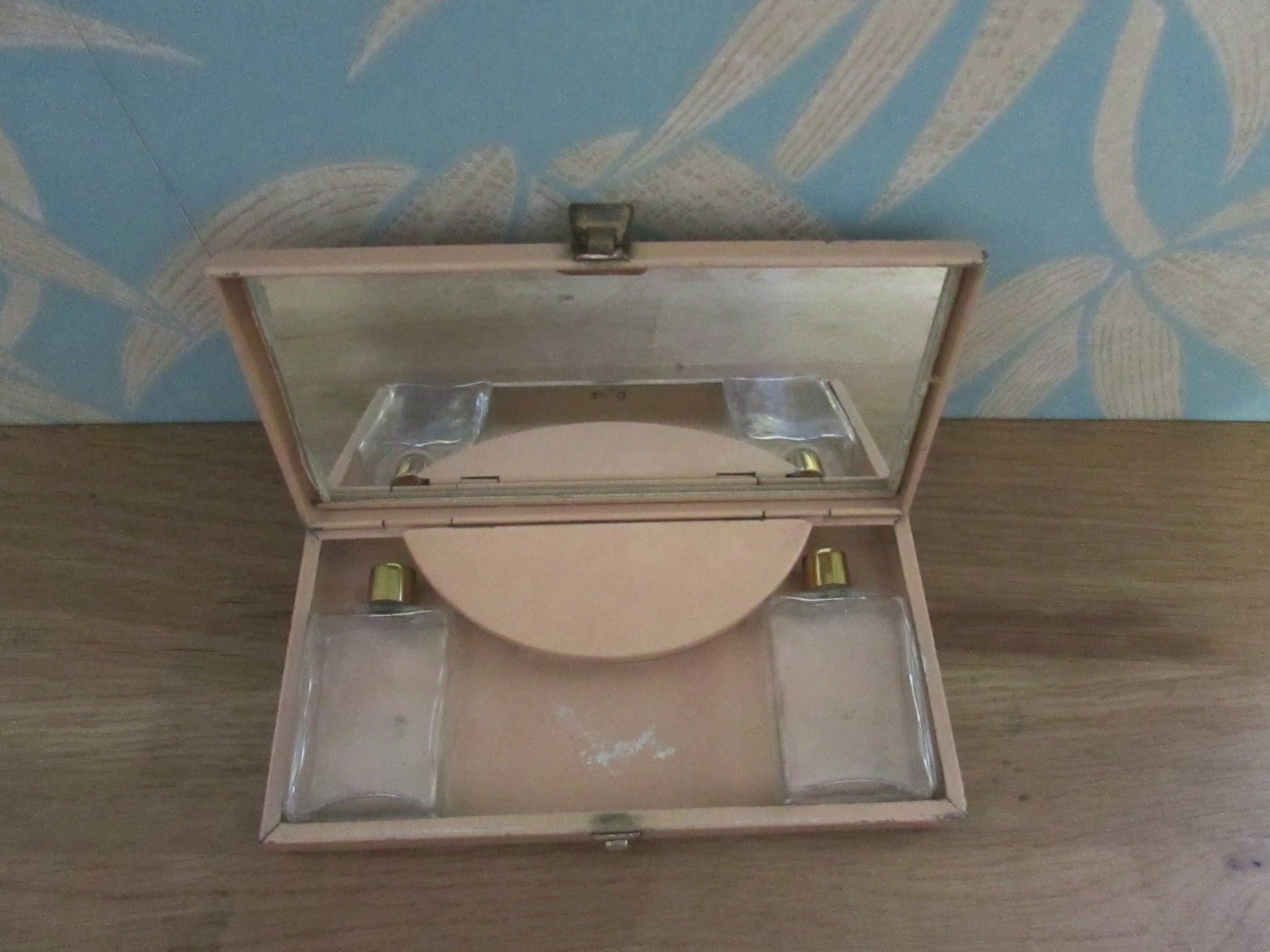 Mid-century travel vanity set in peach-coloured metal case