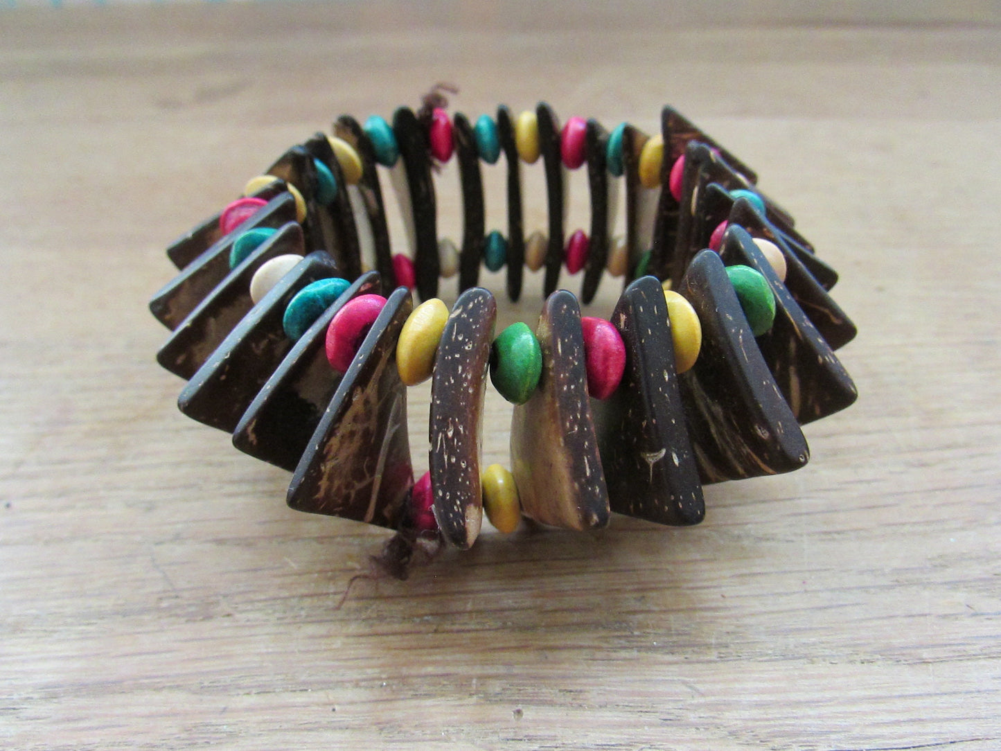Vintage hand-made coconut shell elasticated bracelet with multi-coloured bead spacers