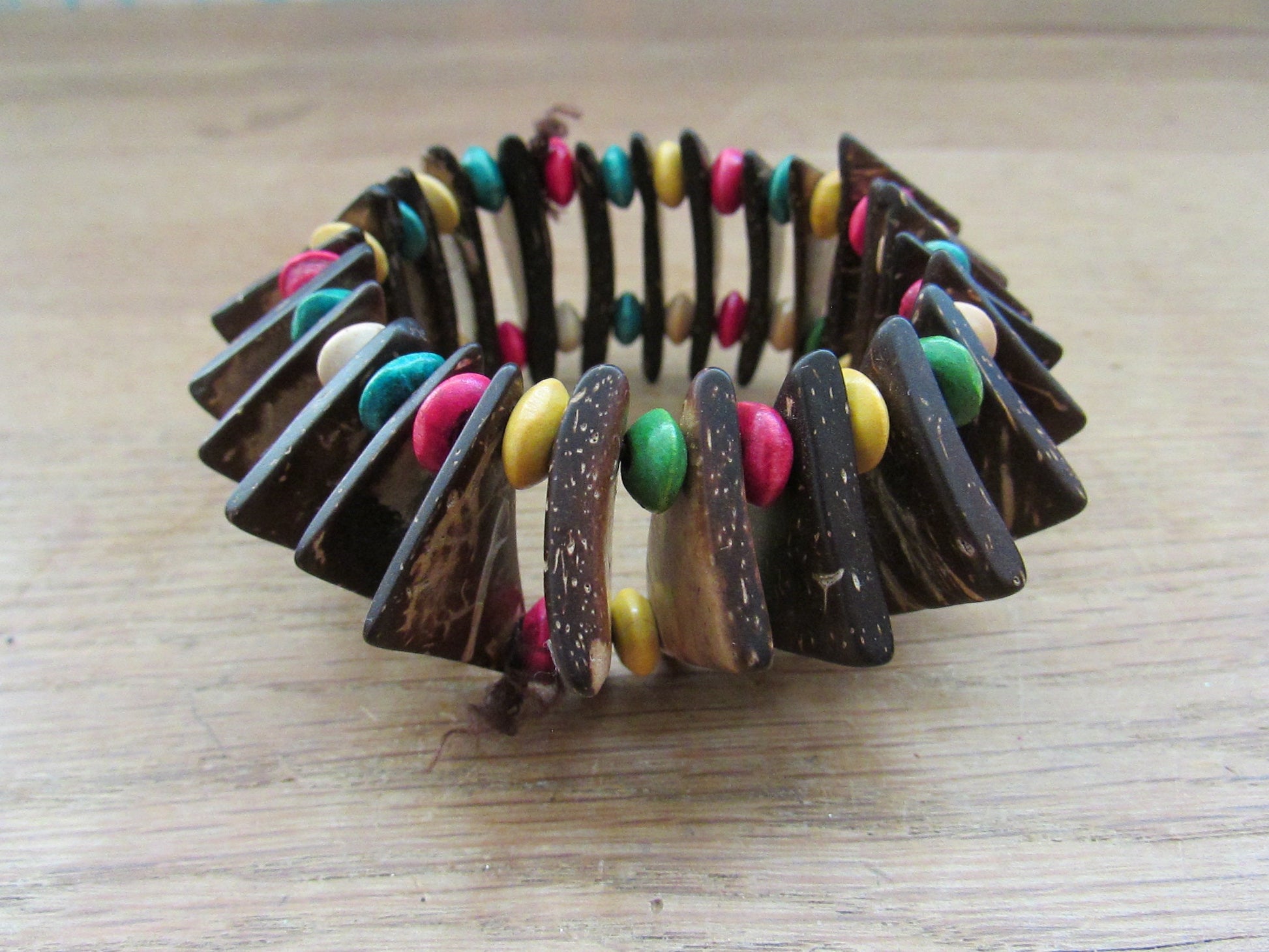 Vintage hand-made coconut shell elasticated bracelet with multi-coloured bead spacers