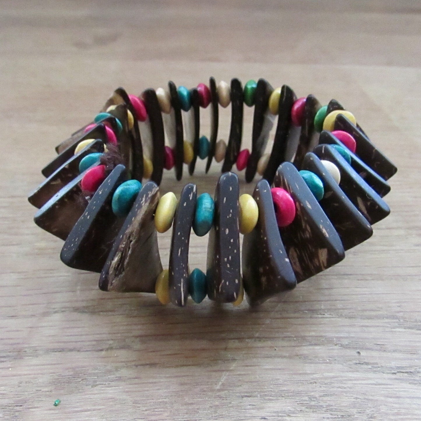 Vintage hand-made coconut shell elasticated bracelet with multi-coloured bead spacers