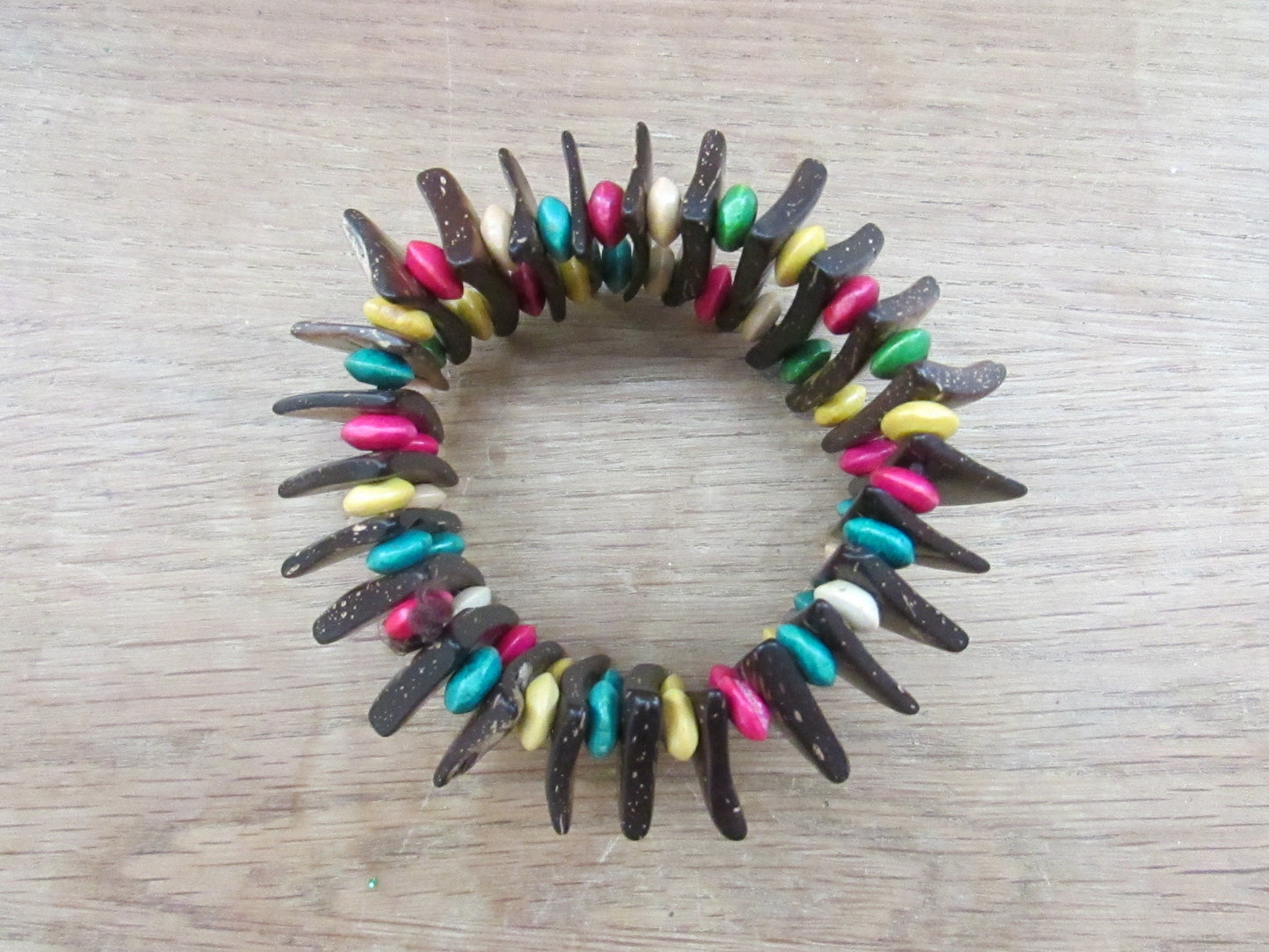 Vintage hand-made coconut shell elasticated bracelet with multi-coloured bead spacers