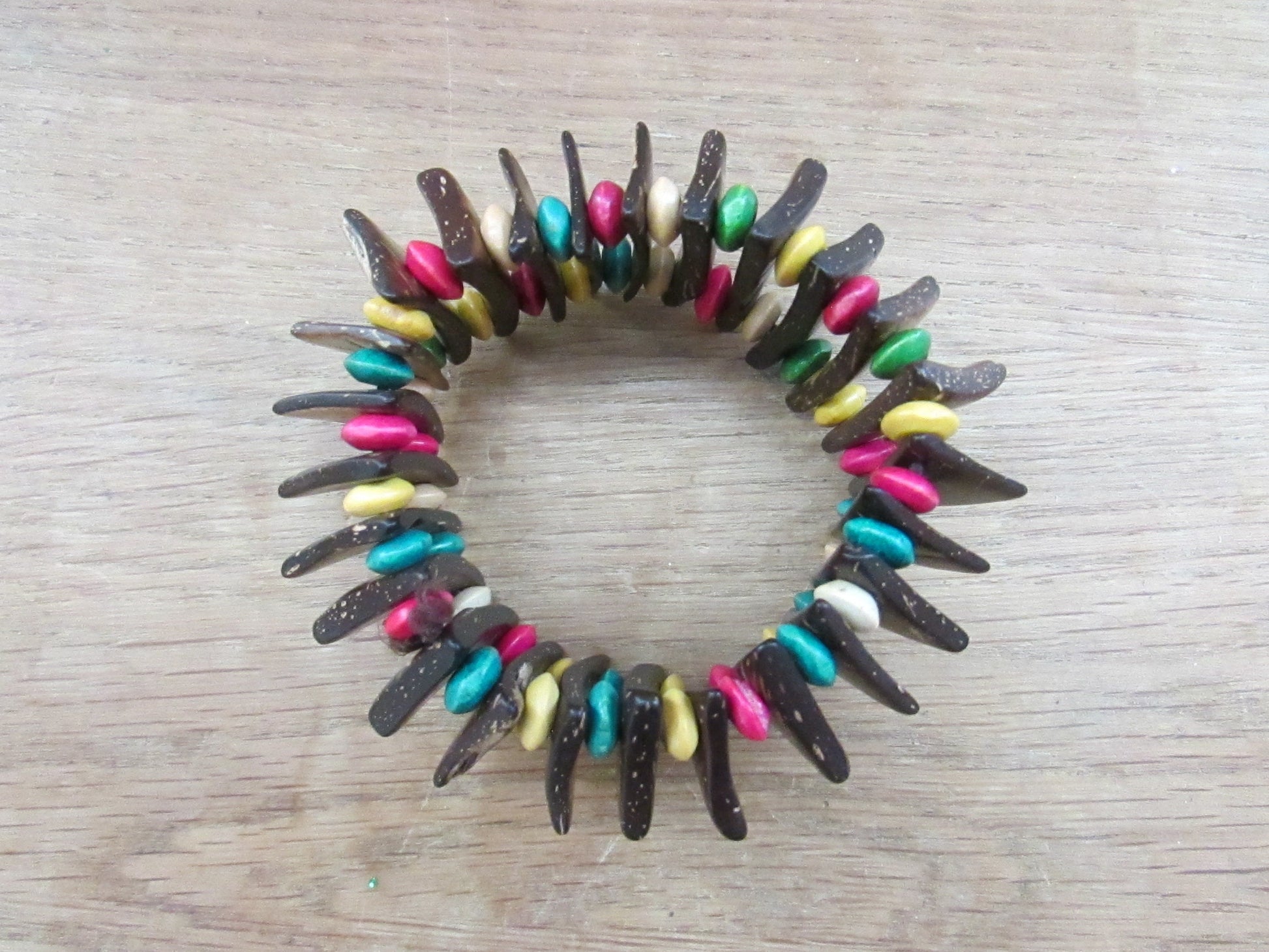Vintage hand-made coconut shell elasticated bracelet with multi-coloured bead spacers