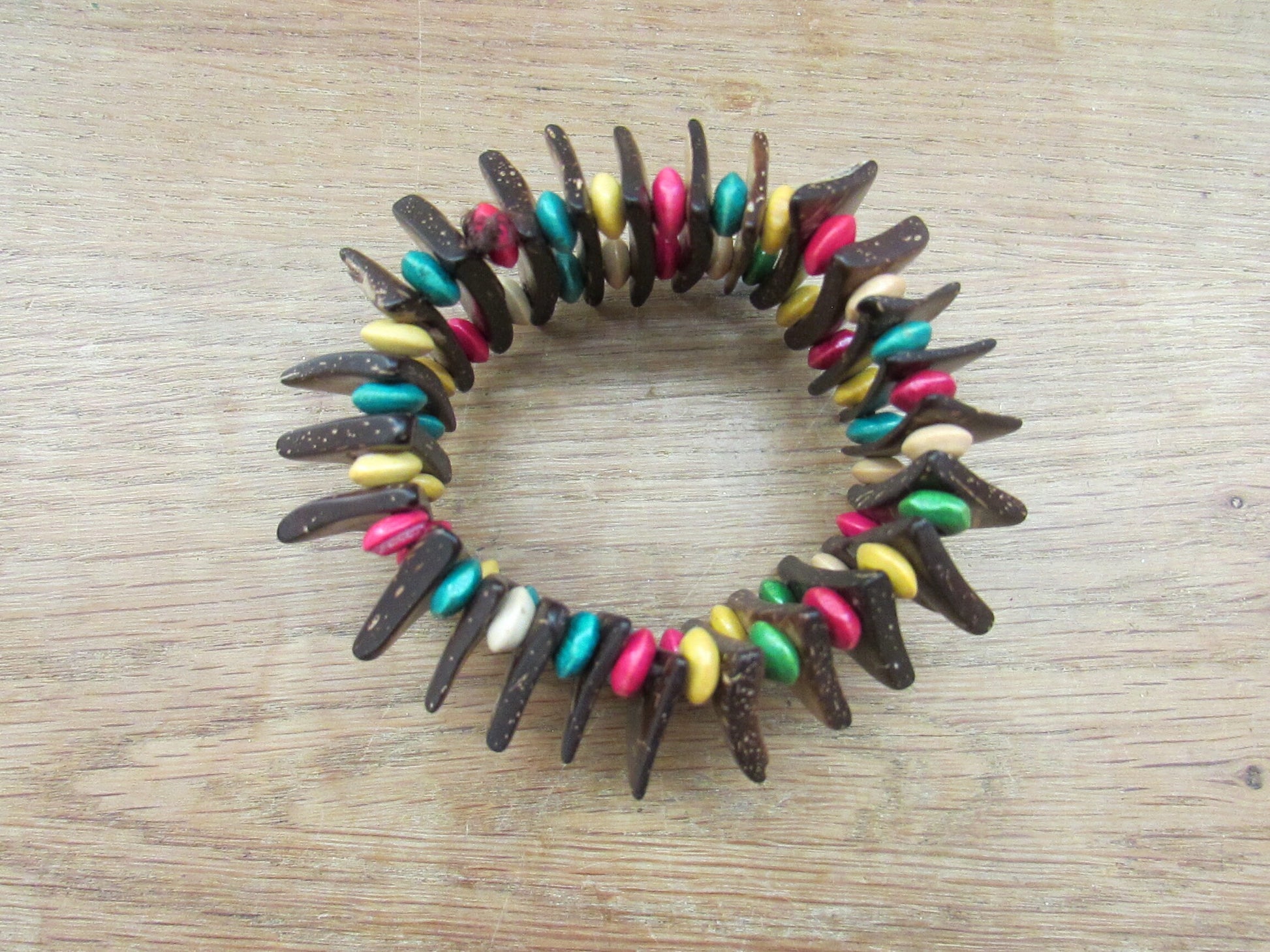 Vintage hand-made coconut shell elasticated bracelet with multi-coloured bead spacers