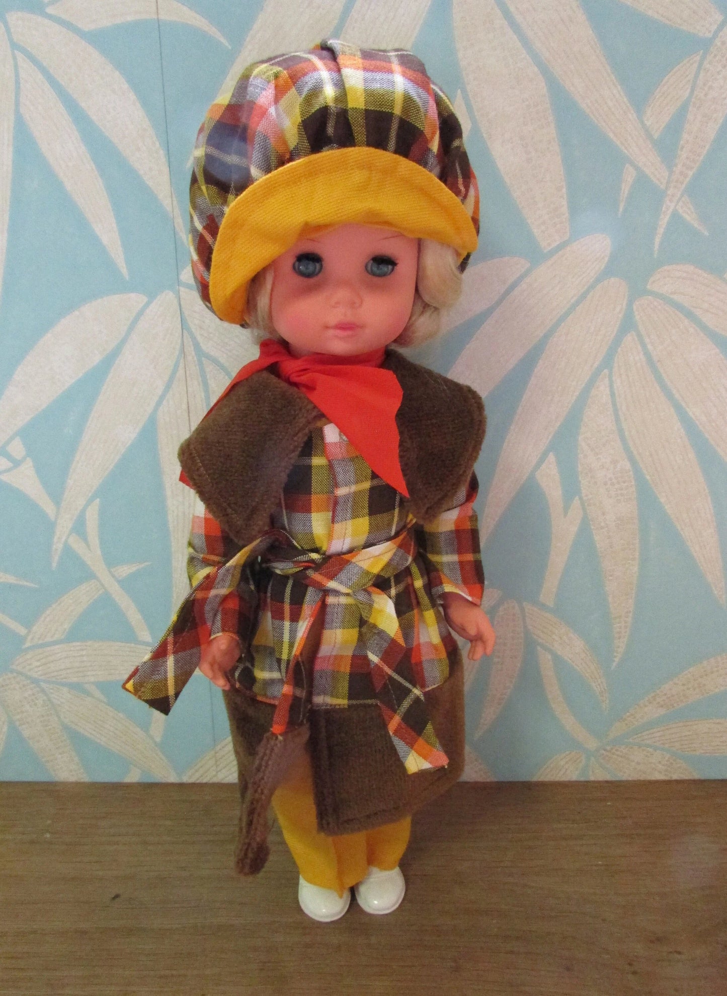 1970s plastic sleepy eye doll in cool tartan coat and matching hat