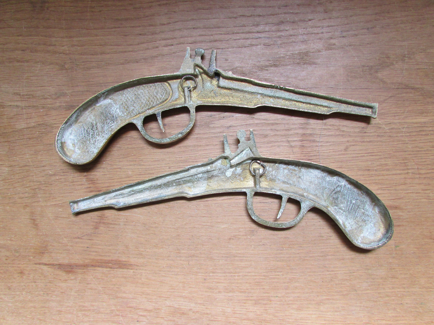 Pair of vintage wall hanging flat brass flintlock pistols