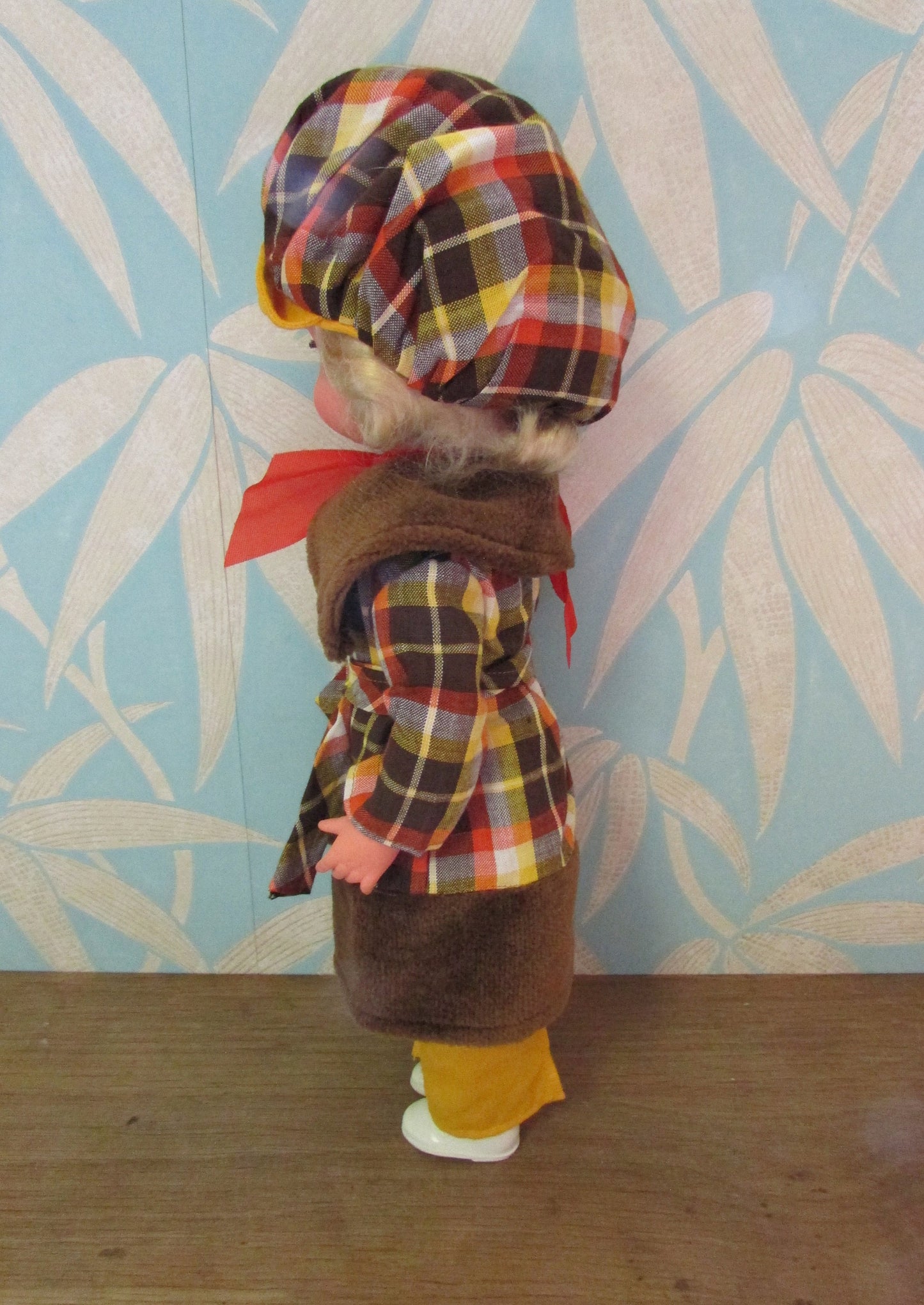 1970s plastic sleepy eye doll in cool tartan coat and matching hat