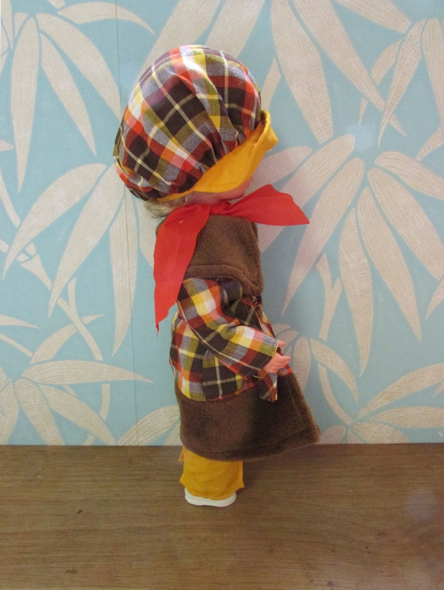 1970s plastic sleepy eye doll in cool tartan coat and matching hat