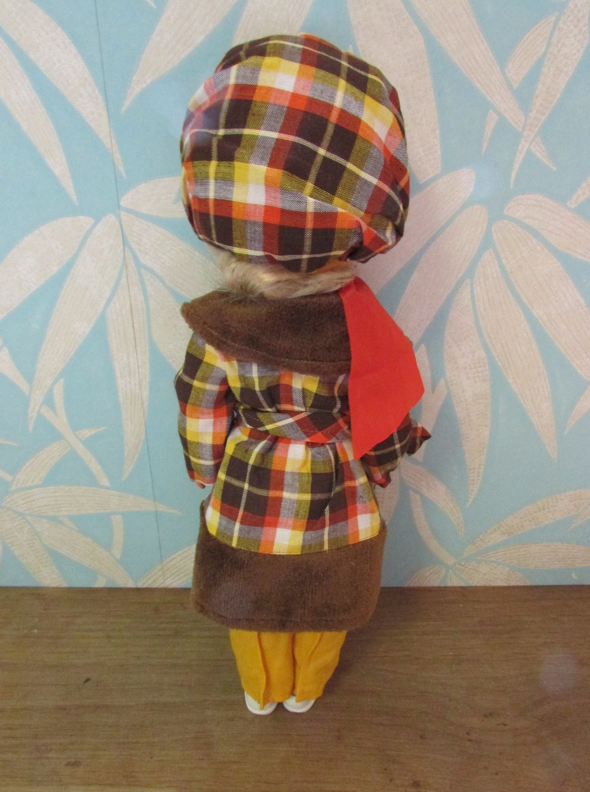 1970s plastic sleepy eye doll in cool tartan coat and matching hat
