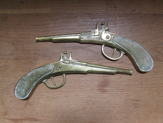 Pair of vintage wall hanging flat brass flintlock pistols