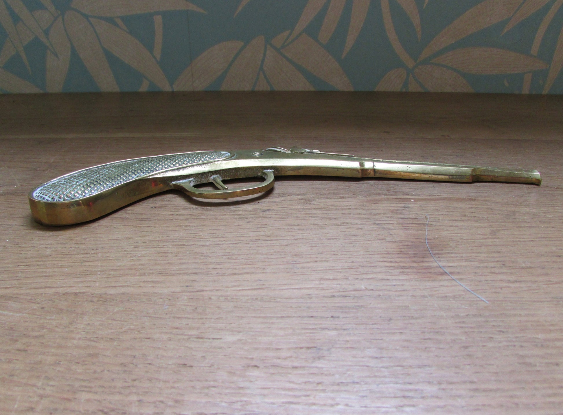 Pair of vintage wall hanging flat brass flintlock pistols