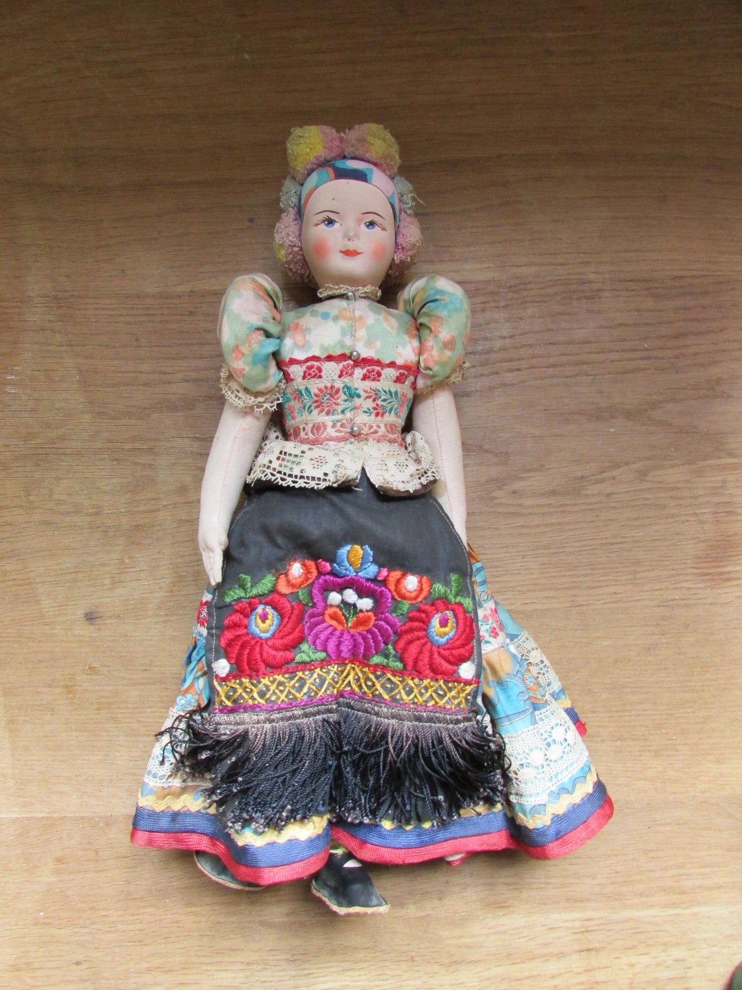Vintage Hungarian folk art doll in traditional dress, with handpainted porcelain face, & cloth limbs