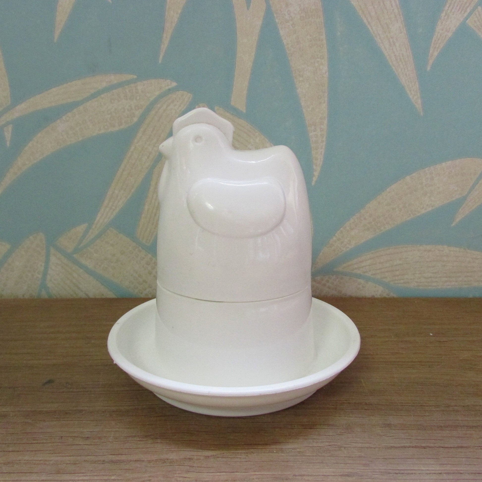 Retro white plastic microwaveable chicken-shaped egg poacher
