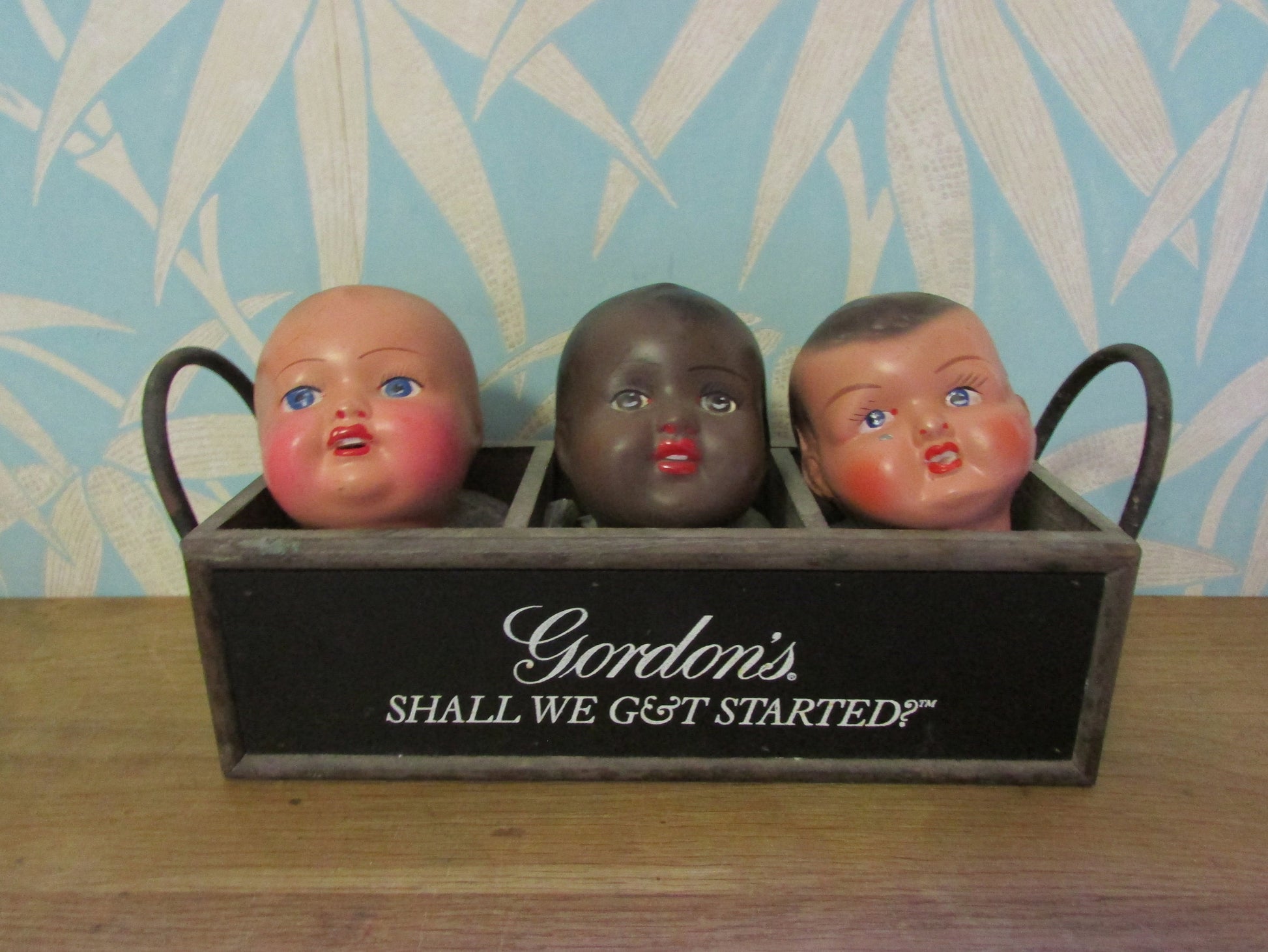 Three antique porcelain baby doll heads - with or without vintage bottle crate