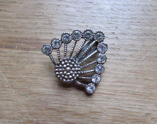 Art Deco-style silver-tone anthemion fan-shaped brooch adorned with crystal stones