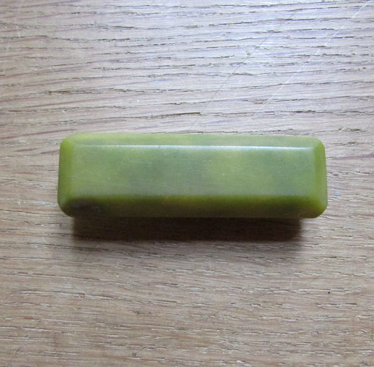 Art Deco green bevelled plastic solid rectangular bar brooch