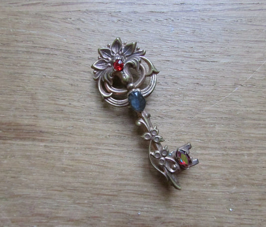 Vintage Coro-style scrolled key brooch with coloured rhinestone detail