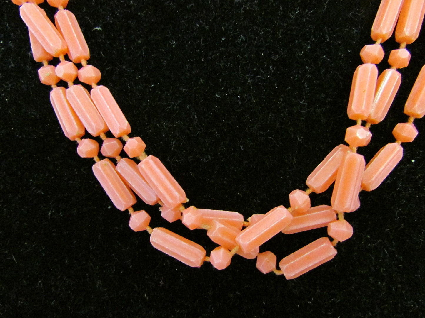 Mid-century fused plastic "dot n dash" coral bead triple strand necklace, silver-tone clasp detail