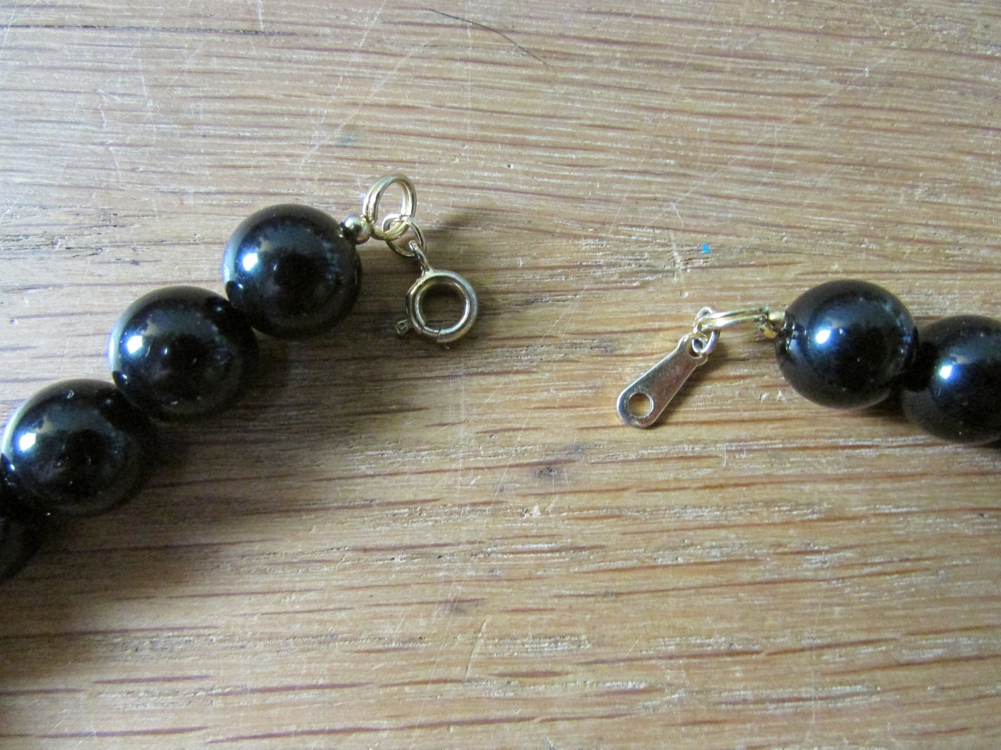 1980s Avon plastic black bead & faux pearl necklace with unusual gold-tone findings