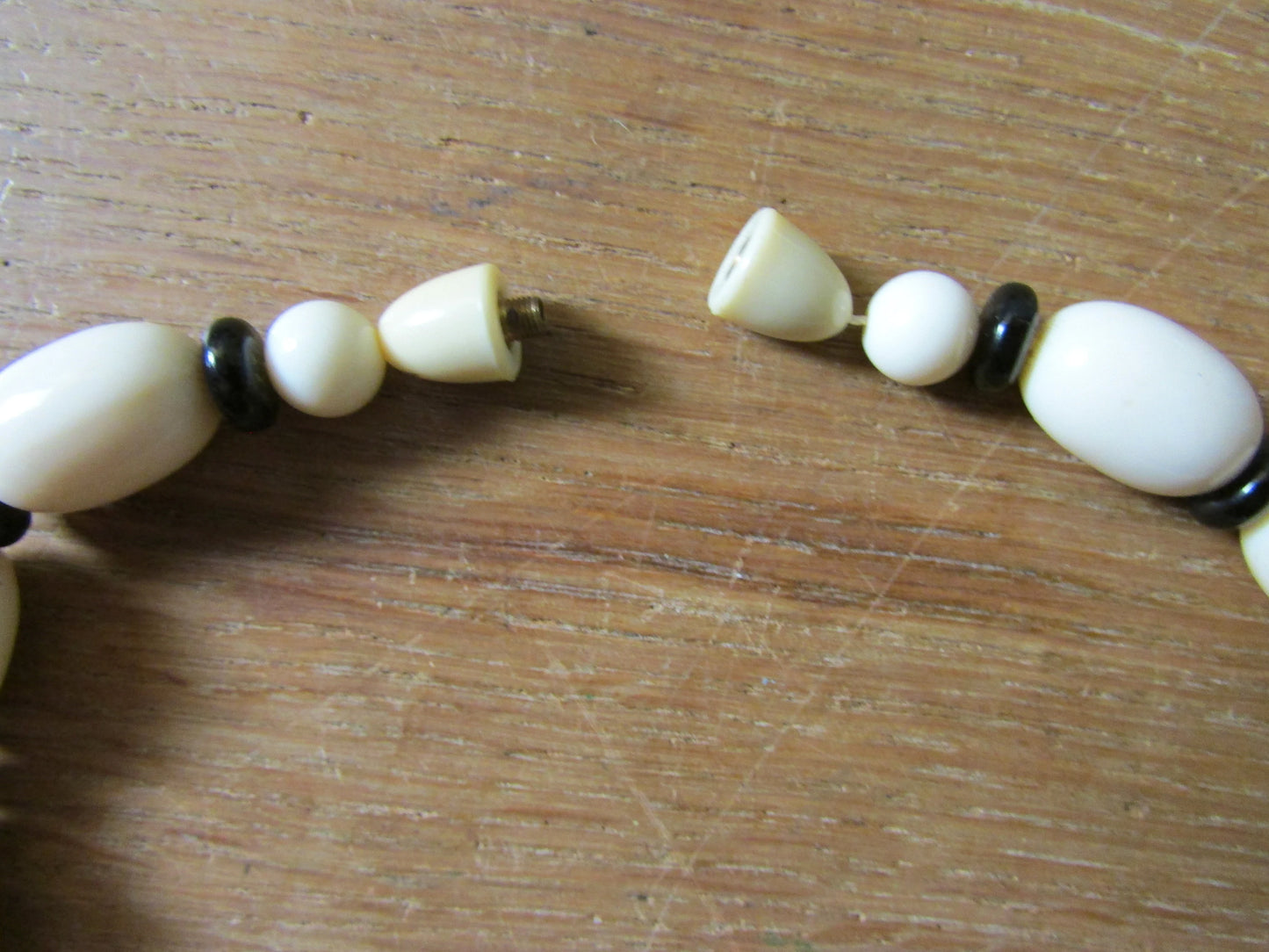 1960s white plastic geometric triangular bead necklace with black spacer beads