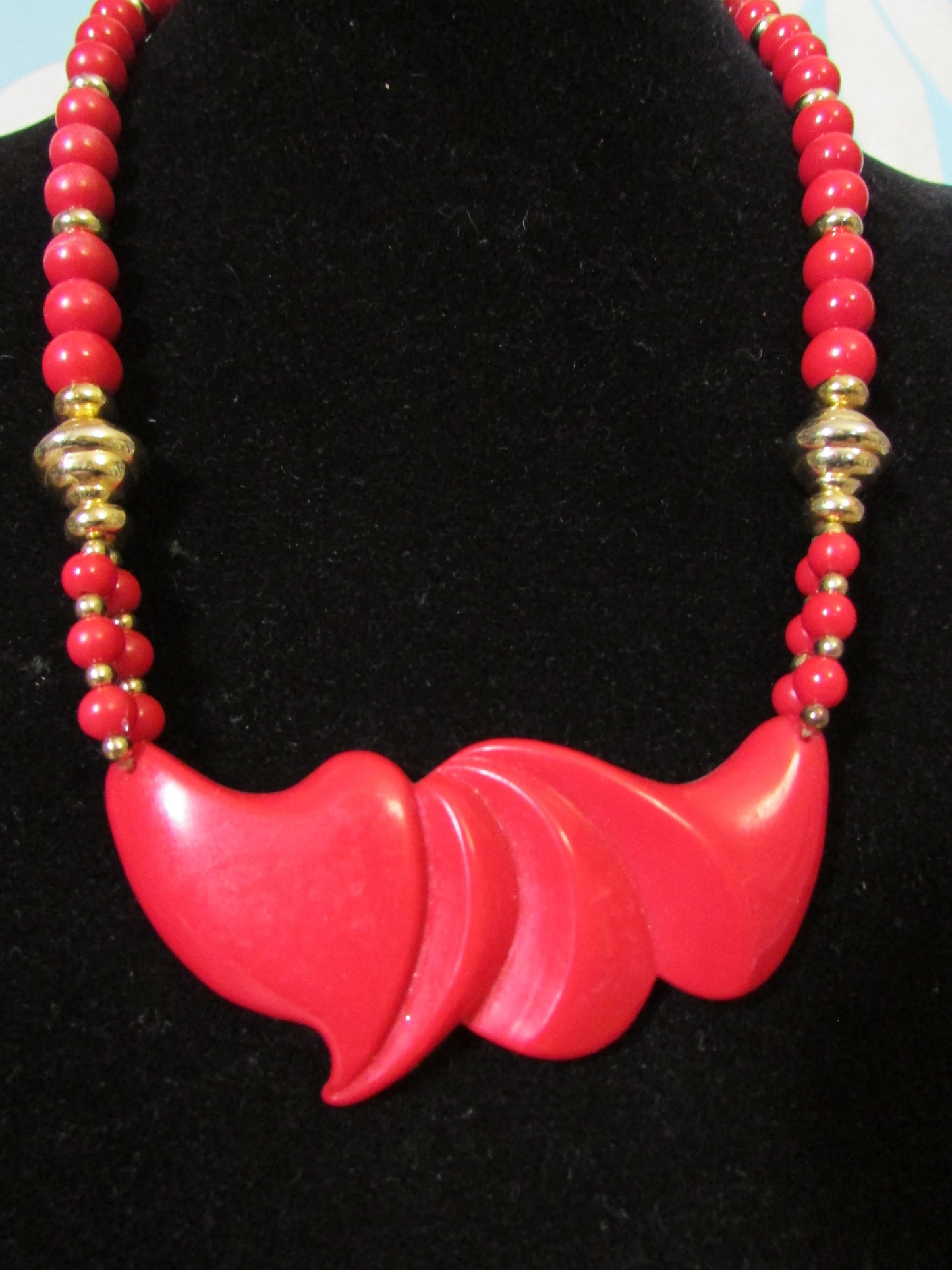 1980s red plastic bead statement necklace with sculptural centrepiece