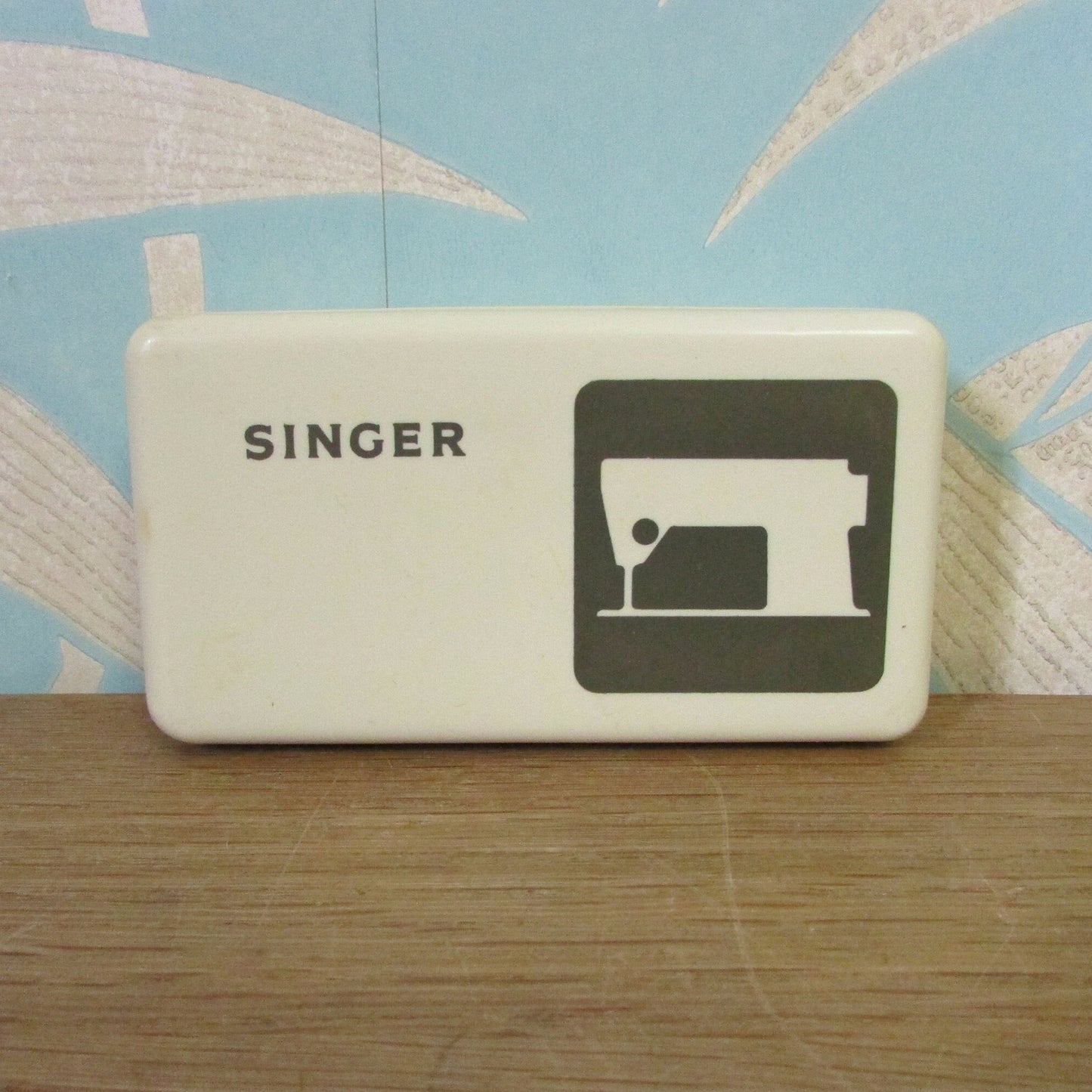 Collectable 1970s Singer hard plastic case containing sewing machine accessories