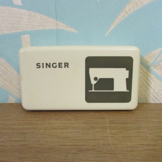 Collectable 1970s Singer hard plastic case containing sewing machine accessories