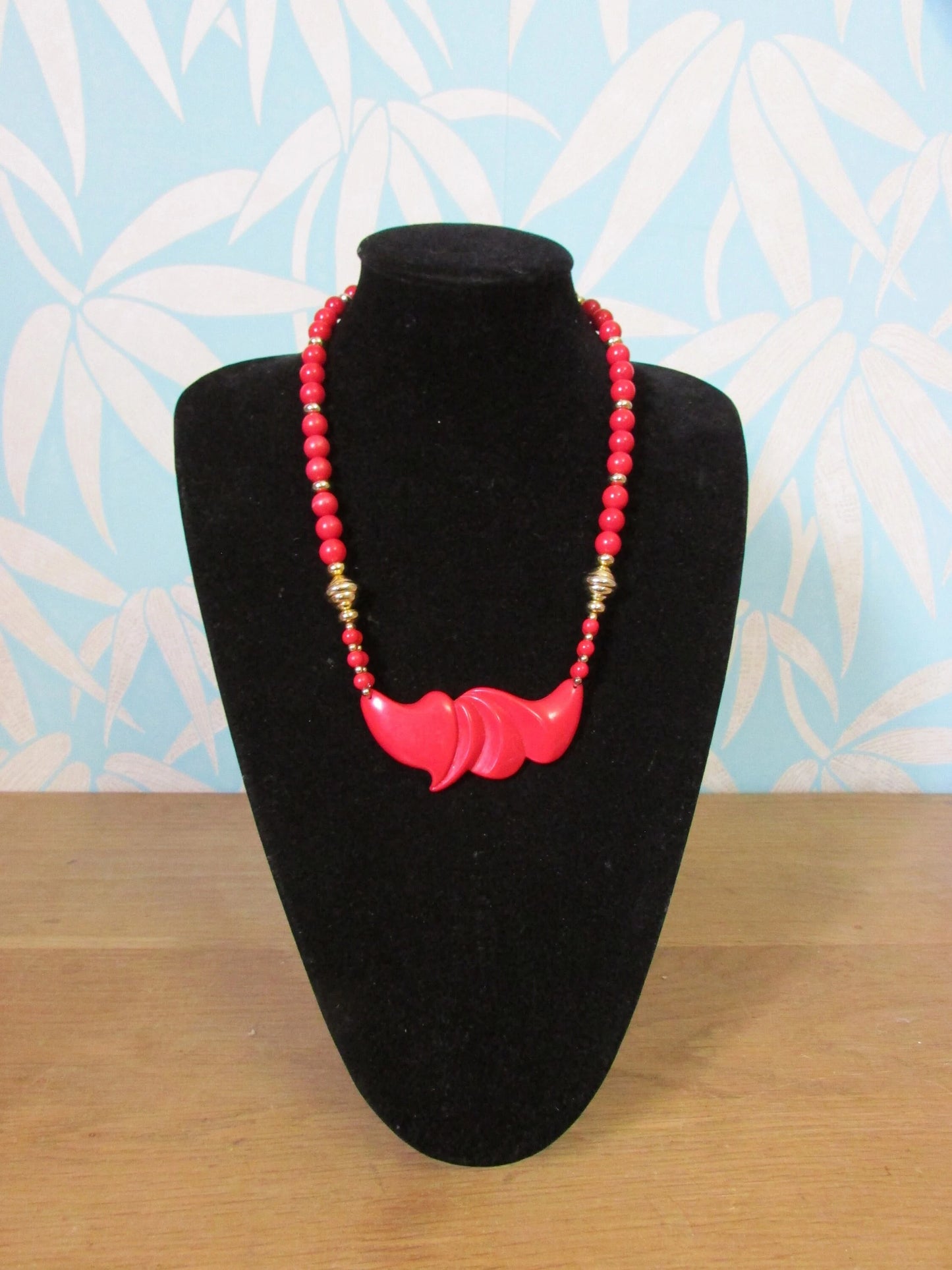1980s red plastic bead statement necklace with sculptural centrepiece