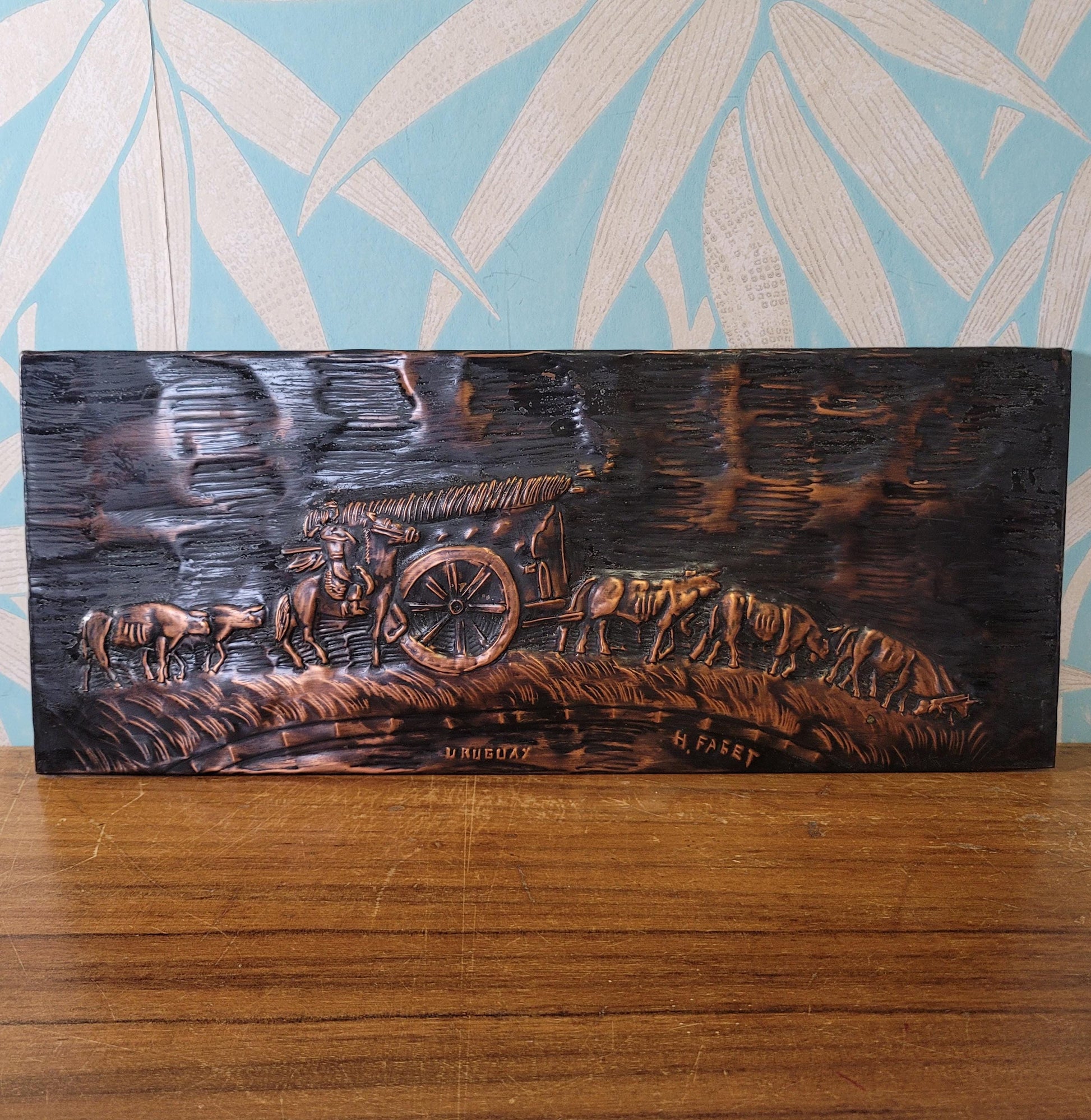 Vintage hammered copper plaque depicting La Carreta, Uruguay, signed by artist
