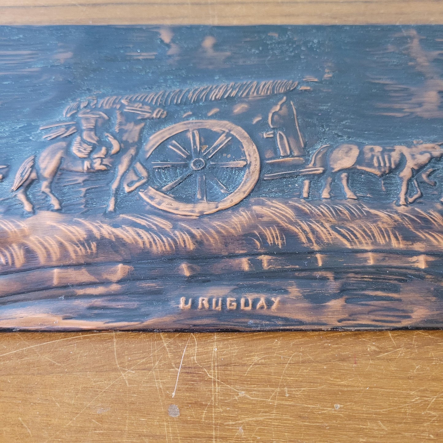 Vintage hammered copper plaque depicting La Carreta, Uruguay, signed by artist