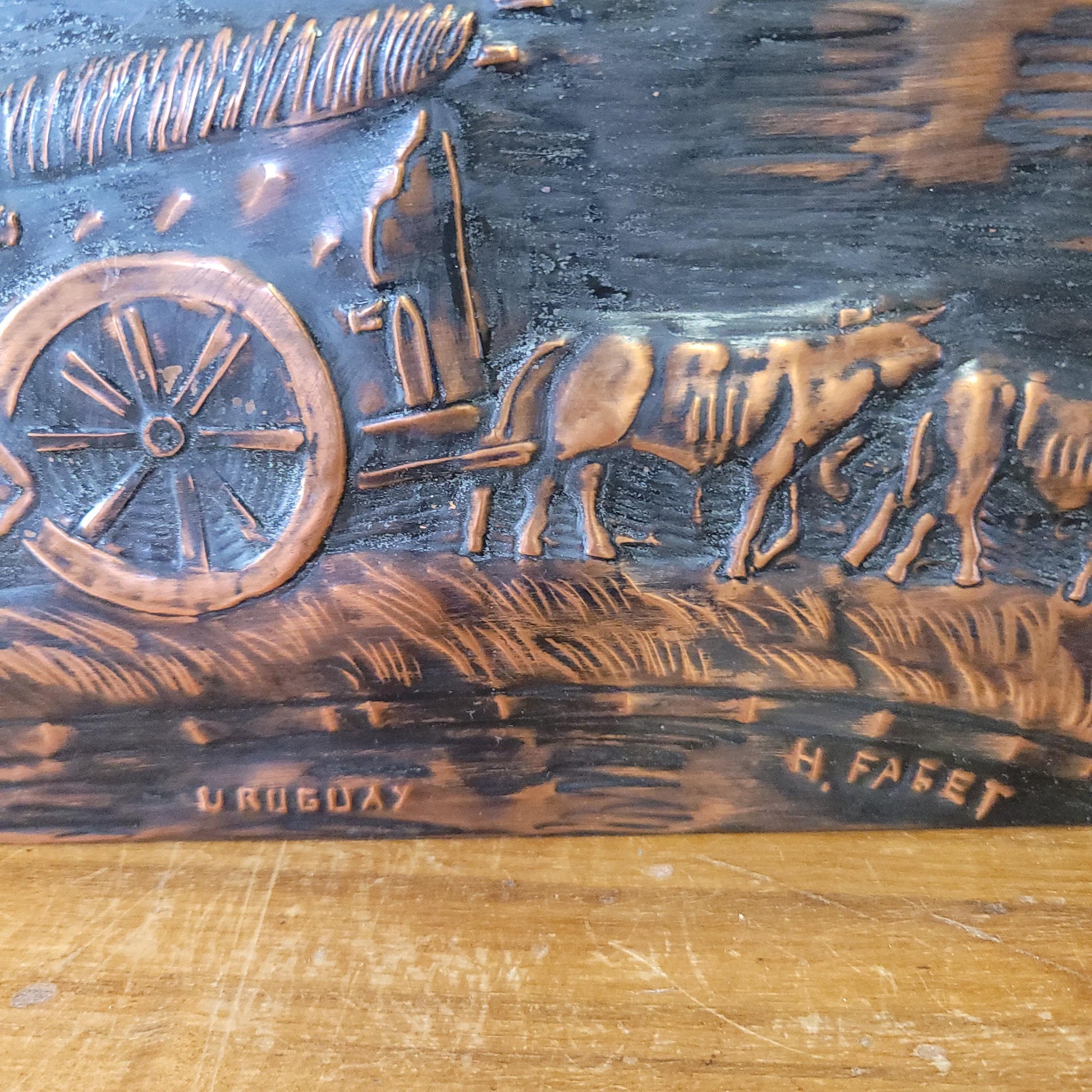 Vintage hammered copper plaque depicting La Carreta, Uruguay, signed by artist