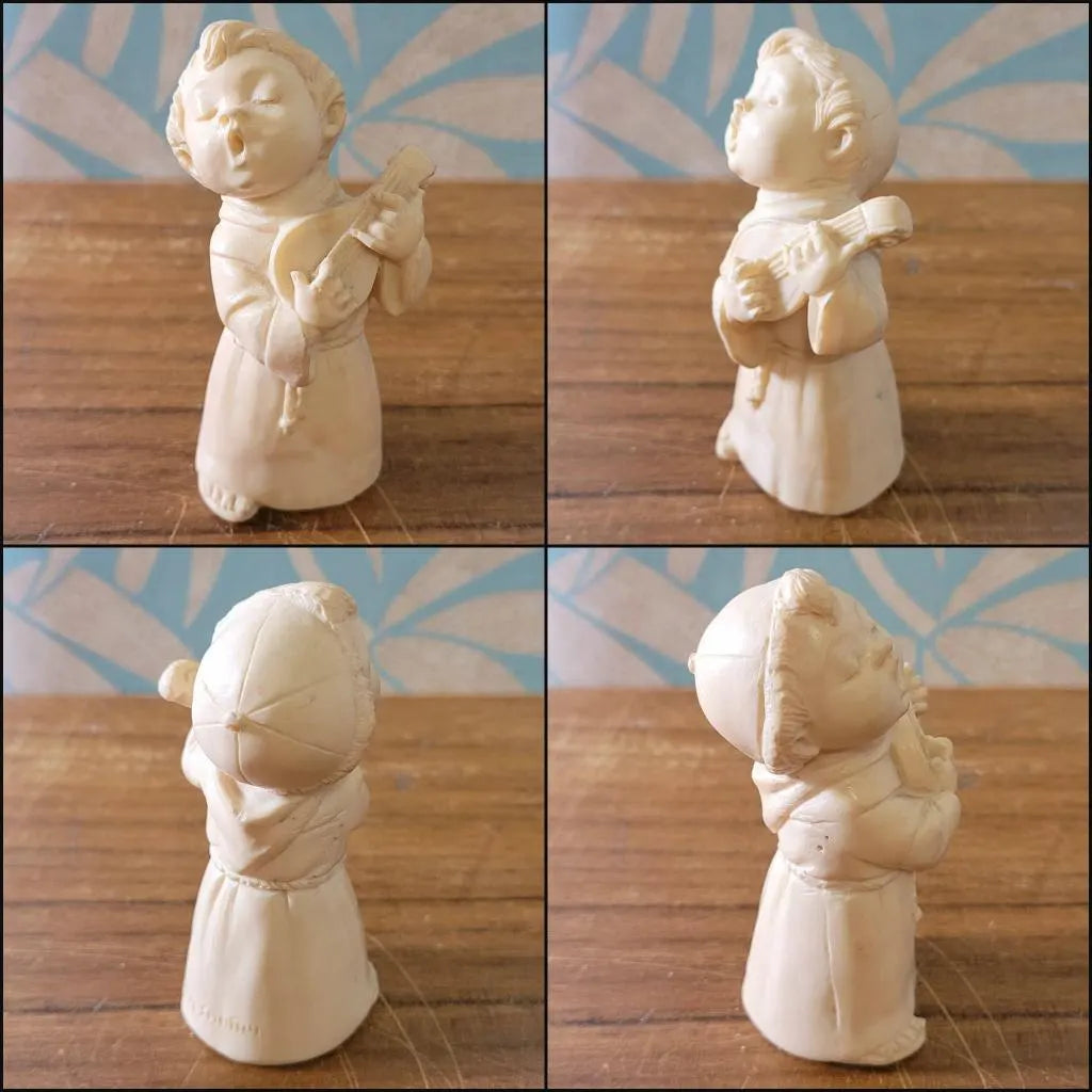 Pair of 1960s/70s ivory-coloured resin singing monk figurines, signed A. Santini