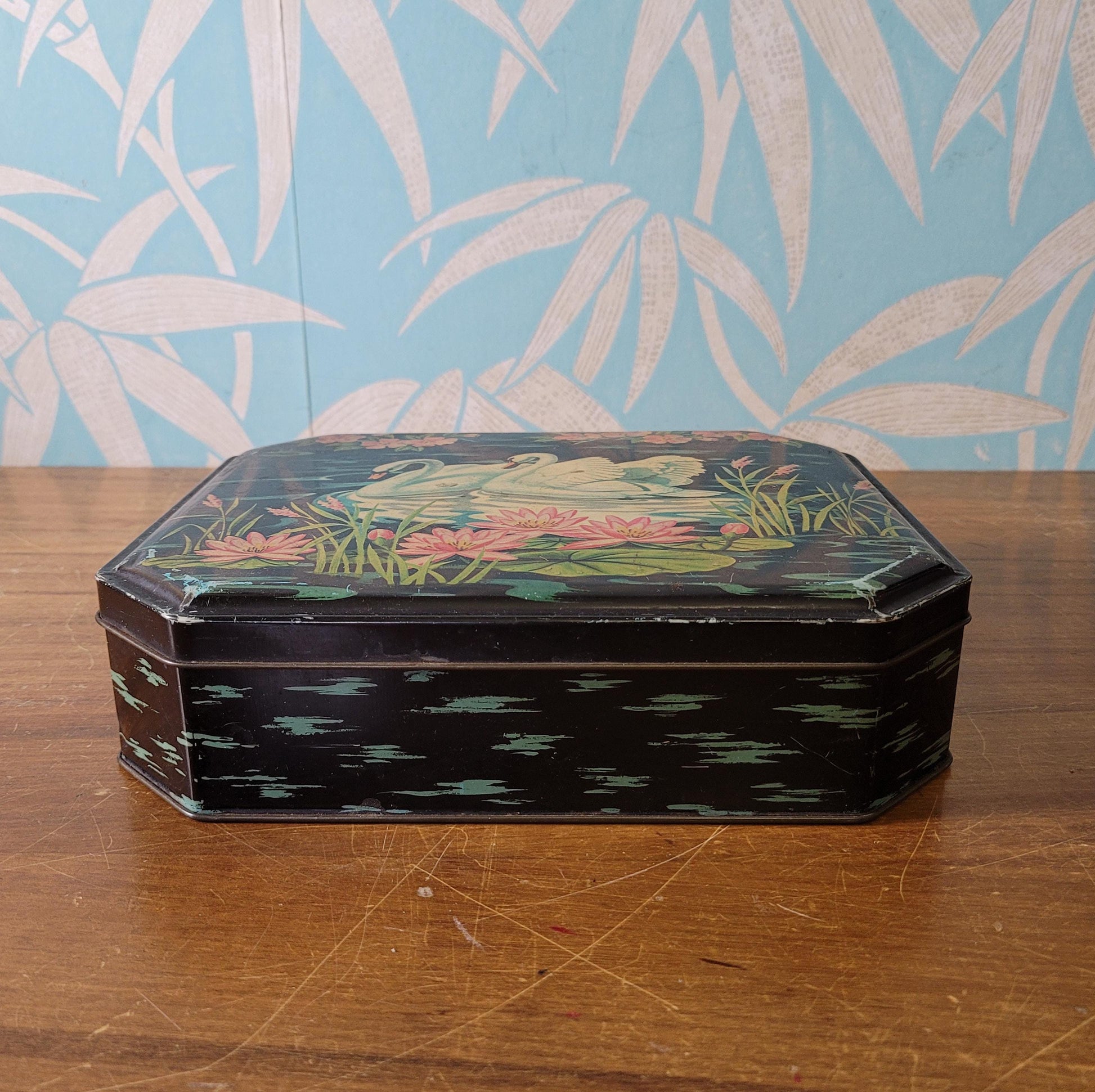 circa. 1950s Burtons Gold tin biscuit box depicting two swans swimming amongst lily pads