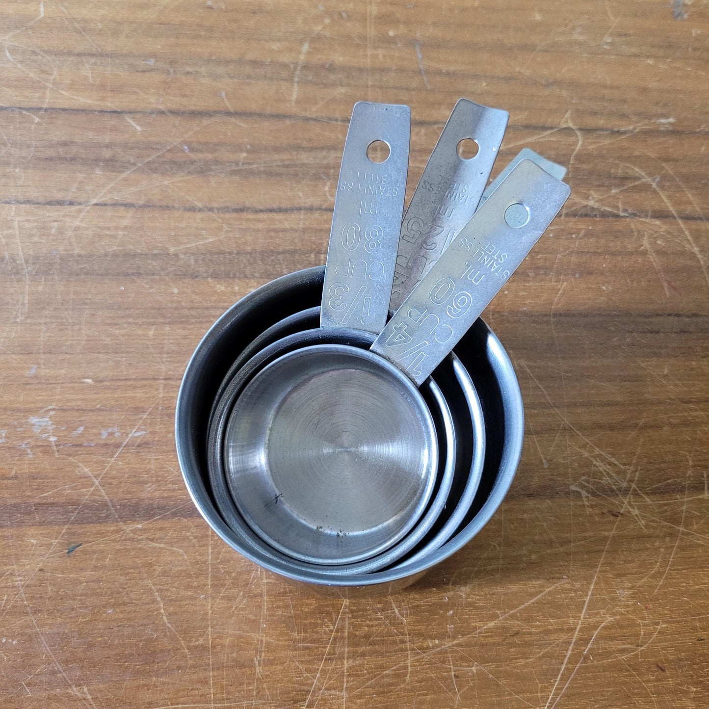 Set of four 1970s stainless steel measuring cups